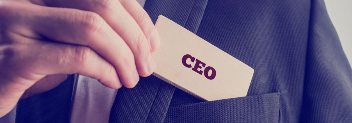 Close-up-of-a-hand-putting-a-CEO-badge-into-their-